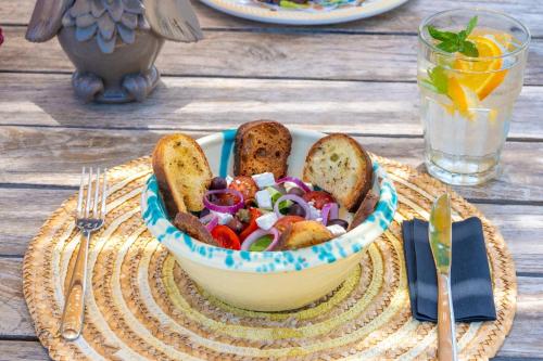 a bowl of salad with bread and toast on a table at Masseria Borgo Sentinella in Torre dell'Orso