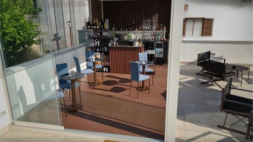 a room with a bar with chairs and a counter at Relais Ulivo Ariana in Gaeta