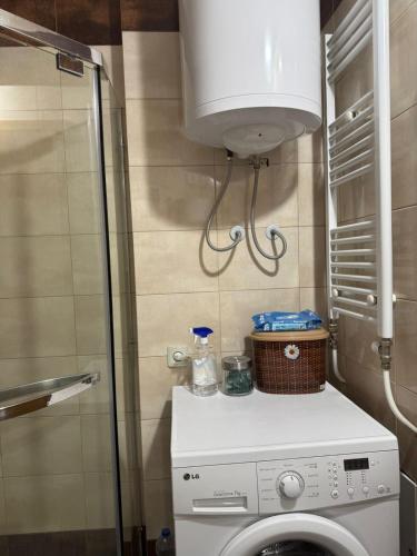 a washer and dryer in a bathroom with at LS Apartment in Kosovo Polje