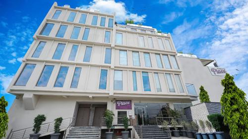 a tall white building with a lot of windows at Regenta Place Jaipur Sirsi Road, Jaipur in Jaipur