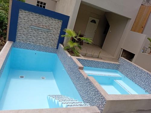 a swimming pool in the middle of a house at Mountain View Vacation Home in Petite Soufrière