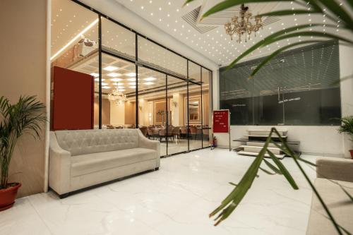a living room with a couch and a table at Tripli Hotels Evara Inn in Varanasi