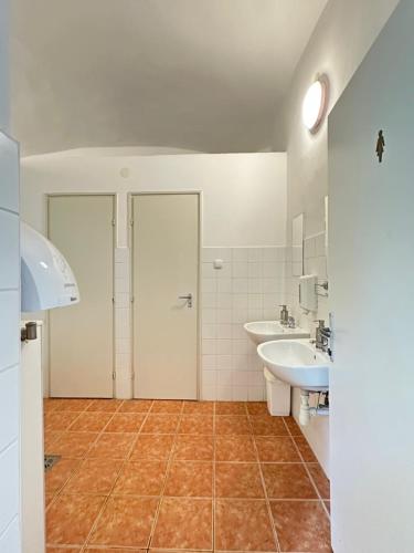 a bathroom with a sink and a toilet and a sink at Stúdió apartman in Kővágóörs