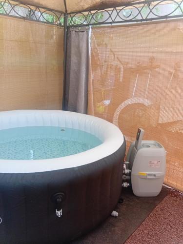 a jacuzzi tub in a tent with a toilet at Aloes Lagoon Lodge in Saint-Paul