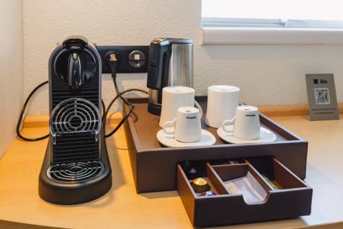 a black blender sitting on top of a table at Hotel ibis Rennes Centre Gare Sud in Rennes