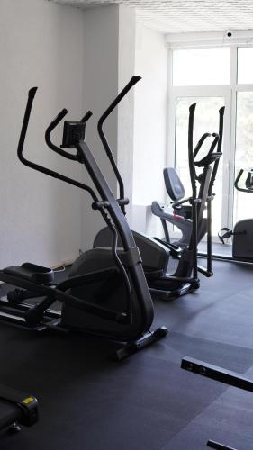 a gym with three cardio machines in a room at Hotel Montana SPA in Kruševo