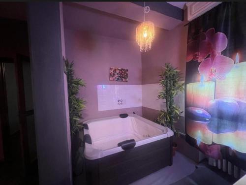 a bathroom with a tub with two plants in it at Apartment with Jacuzzi in Parma in Parma