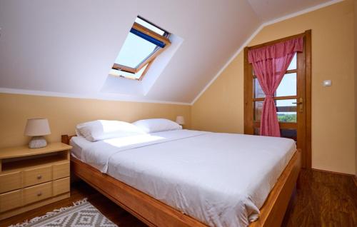 a bedroom with a large bed and a window at Holiday Home Dubranec by Villas Guide in Dubranec