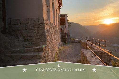 a view of a building with the sunset in the background at Le Nid du Vigneron I Authentic escape in Cuges-les-Pins