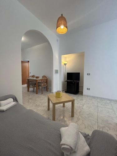 a living room with a bed and a table at Green Appartament in Marina di Camerota