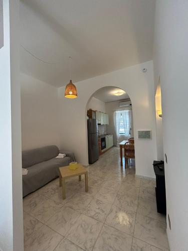 a living room with a couch and a table at Green Appartament in Marina di Camerota