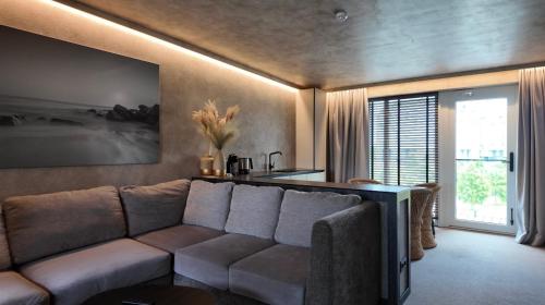 a living room with a couch and a table at VAIVA Apartments, Palanga in Šventoji