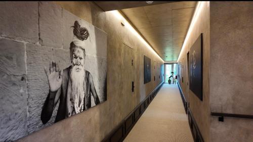a hallway with paintings on the walls of a building at VAIVA Apartments, Palanga in Šventoji