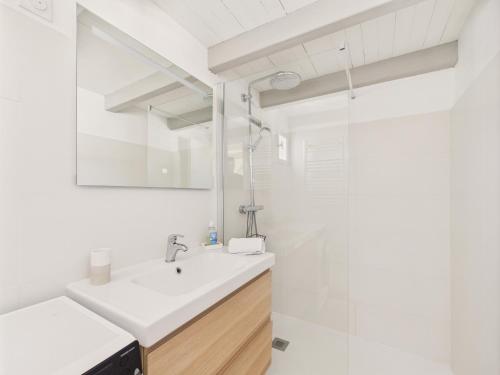 a white bathroom with a sink and a shower at Saint Clément - 400 m plage - Cœur village in Saint-Clément-des-Baleines