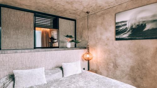 a bedroom with a bed and a large mirror at VAIVA Apartments, Palanga in Šventoji