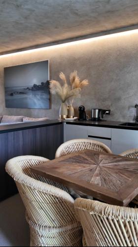 a dining room with a table and two chairs at VAIVA Apartments, Palanga in Šventoji
