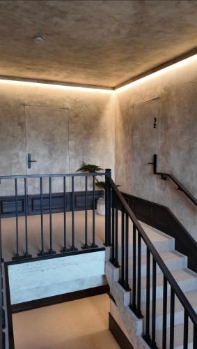 a staircase in a building with a ceiling at VAIVA Apartments, Palanga in Šventoji