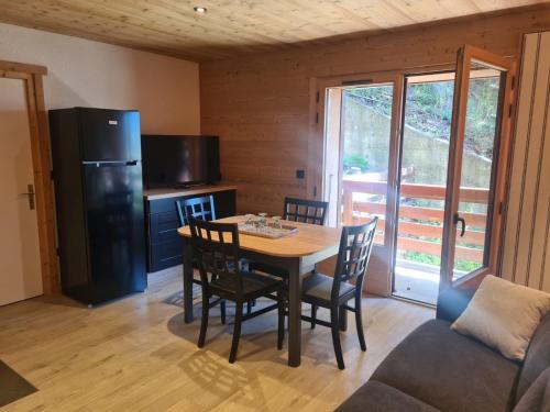 a kitchen and dining room with a table and chairs at Ma P'tite Étoile in Le Grand-Bornand