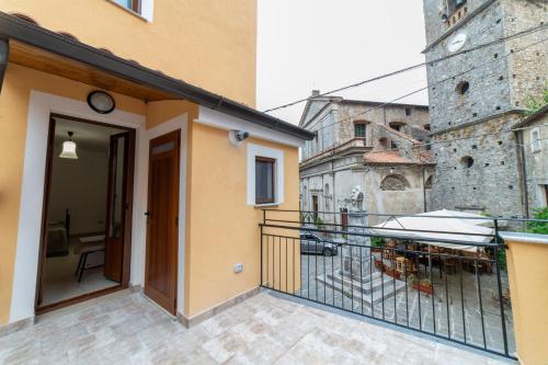 a balcony of a building with a door and a building at B&B Magliuolo in San Giovanni a Piro
