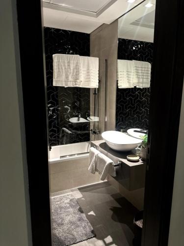 a bathroom with two sinks and a toilet and a tub at Canal View Studio in AG Tower in Sabkhah