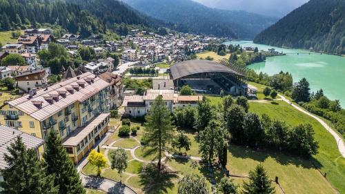 an aerial view of a town next to a lake at HOTEL AURONZO - outdoor basecamp in Auronzo di Cadore