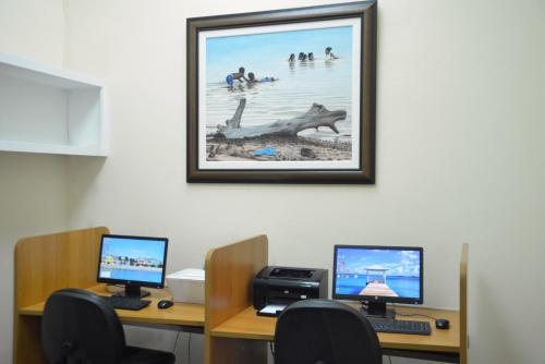 an office with two computers and a picture on the wall at Sandyport Beach Resort in Nassau