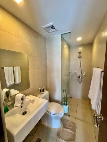 a bathroom with a sink and a toilet and a shower at Homestayed ilo in Iloilo City