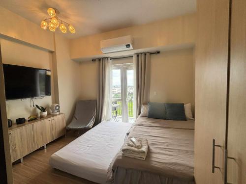 a bedroom with a large bed and a window at Homestayed ilo in Iloilo City