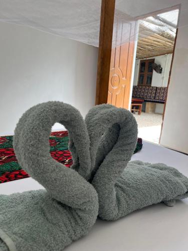 a pile of towels sitting on a table at Reef 2Nungwi House in Nungwi