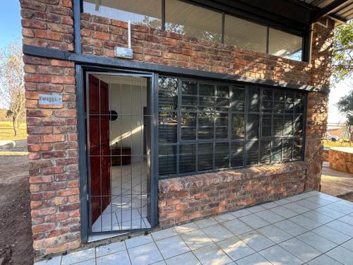 a brick building with a revolving door in it at Impala Game Ranch in Dinokeng Game Reserve
