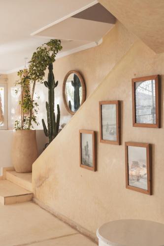 a staircase in a house with pictures on the wall at Blue Kaouki Boutique Hotel in Sidi Kaouki