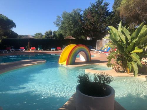 a swimming pool with a rainbow in the middle at Bungalow vue mer Pampelonne St-Tropez in Saint-Tropez