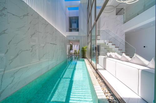 a swimming pool in the middle of a building at 3BR Private Pool Villa near Laguna & Beach - Residence Villa by Warm Plus in Ban Pak Lak