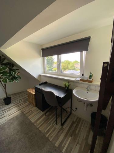 a bathroom with a sink and a window at Cozy Private Room 707 on a Busy Persian Restaurant in Eindhoven