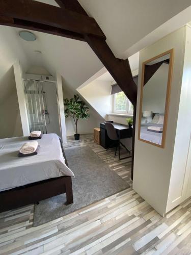 a attic bedroom with a bed and a mirror at Cozy Private Room 707 on a Busy Persian Restaurant in Eindhoven