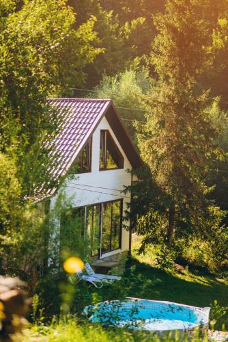 a small white house in the middle of a forest at Sonna in Pidzakharychi