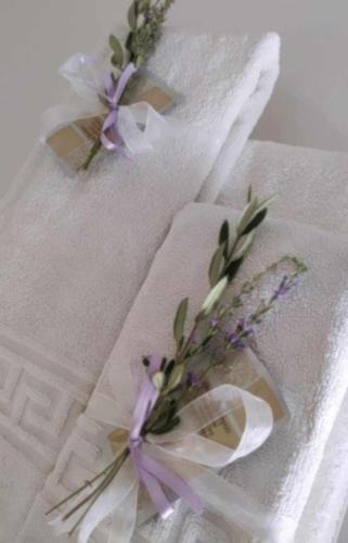 two white towels with flowers on top of them at Casa Vacanze Ogliarola in Manduria
