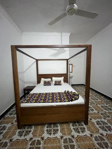 a bed with a canopy in a room at Reef 2Nungwi House in Nungwi