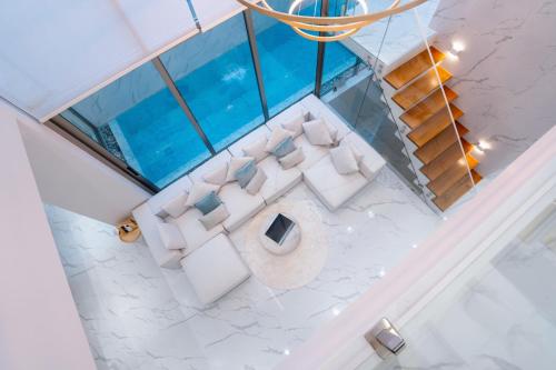 an overhead view of a living room with white furniture at 3BR Private Pool Villa near Laguna & Beach - Residence Villa by Warm Plus in Ban Pak Lak