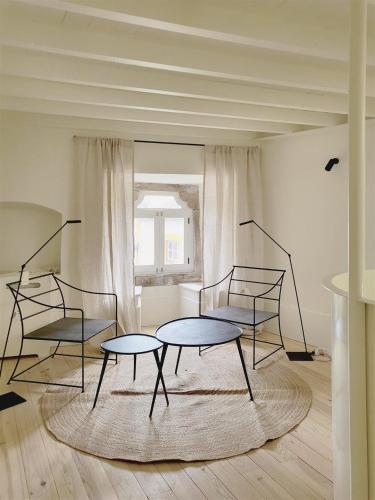 a room with two tables and two chairs in it at Fonte da Vila House in Castelo de Vide