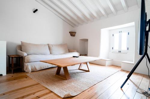 a living room with a couch and a coffee table at Fonte da Vila House in Castelo de Vide