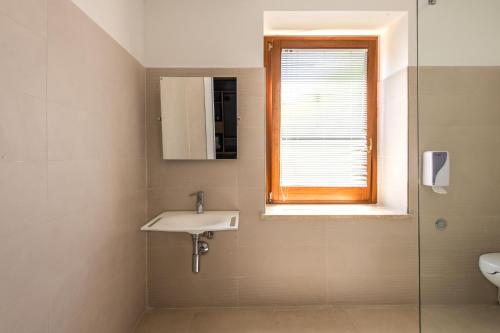 a bathroom with a sink and a window at Villa Margherita in Cefalù