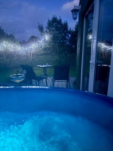 a view of a swimming pool at night at ALANTOS ŽIRGAI Holiday Villas sauna or hottube additional price in Alanta