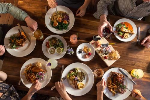 a group of people sitting around a table with plates of food at Squam Lake Inn in Holderness