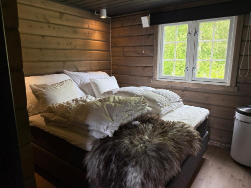 una camera da letto con un letto con cuscini e una finestra di No 105 Kongelberget a Bjorli