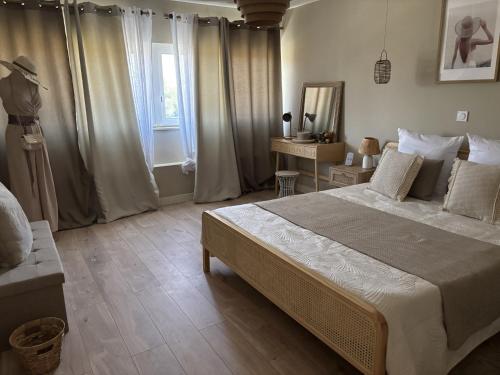 a bedroom with a large bed and a window at Chez Flo la suite in Avignon