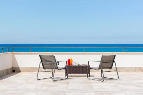 two chairs and a table on a roof at Villa Margherita in Cefalù