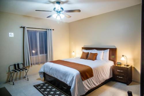 a bedroom with a bed and a ceiling fan at Bugambilias Suites in Loreto