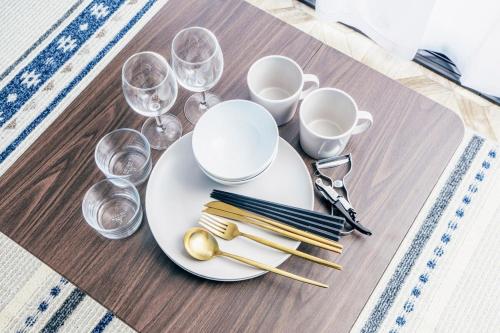 a table with a white plate with glasses and chopsticks at T-Base 01 in Tateyama