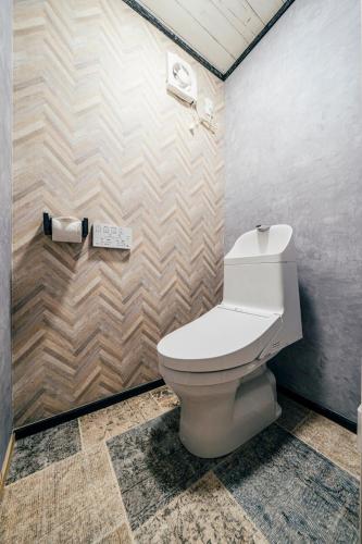 a bathroom with a white toilet in a room at T-Base 01 in Tateyama